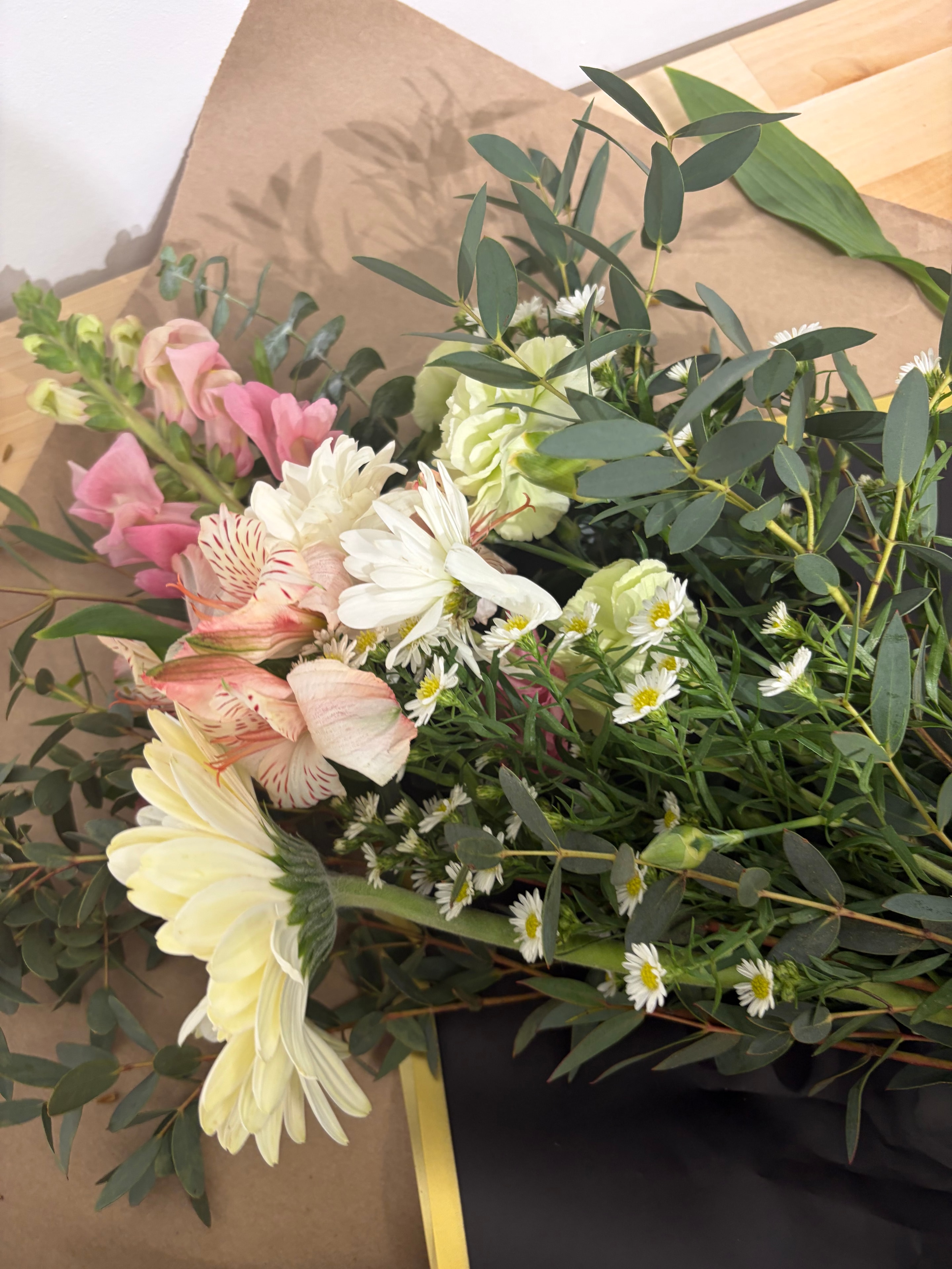 Wrapped pink rose bouquets in kraft paper