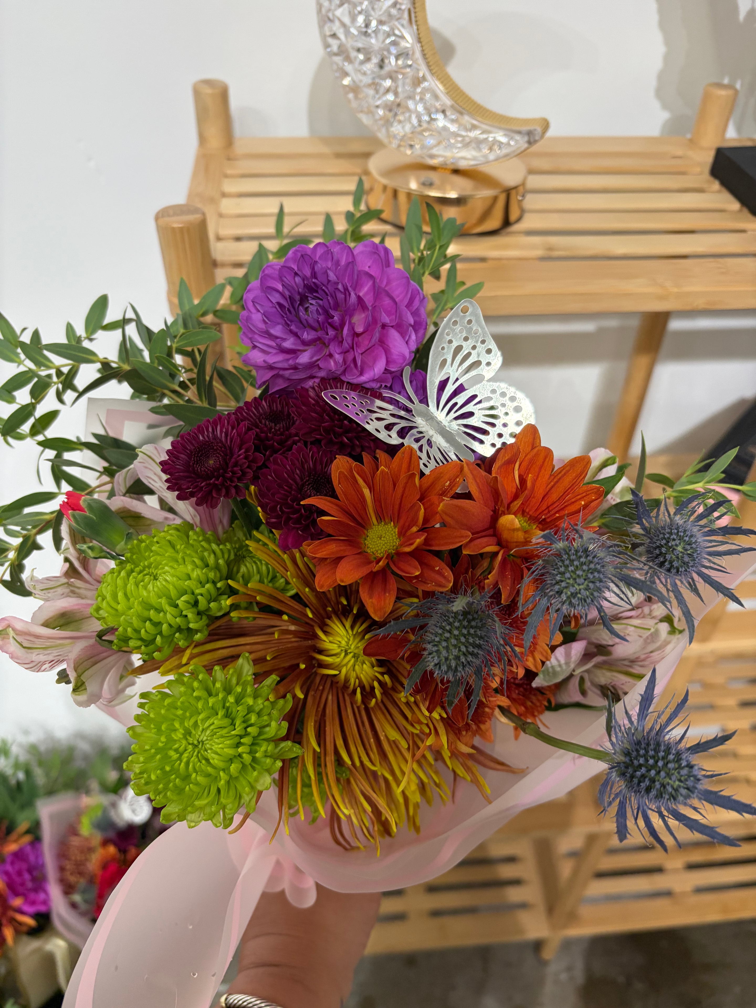 Colorful chrysanthemum bouquet with silver butterfly decorations